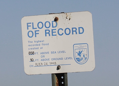 Sign: "Flood of Record 858 ft above sea level or 10 ft above ground level on July 24, 1993"